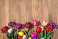 Eggs and tulips easter wooden background