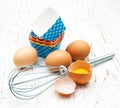 Eggs, whisk and cupcake liners Royalty Free Stock Photo