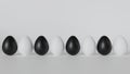 The eggs are white and black. Positioned in a row.