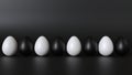 The eggs are white and black. Positioned in a row.