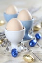 Eggs in white and blue eggcups Royalty Free Stock Photo