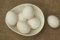 Eggs in a white bowl isoated on table mat. Royalty Free Stock Photo