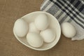 Eggs in a white bowl isoated on table mat. Royalty Free Stock Photo