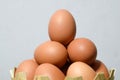 Eggs on white cement wall background - Many eggs in a small bamboo basket on the gray wooden floor, Chicken eggs contain protein Royalty Free Stock Photo