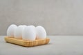 Eggs with white shell in wooden egg holder Royalty Free Stock Photo