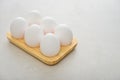 Eggs with white shell in wooden egg holder Royalty Free Stock Photo