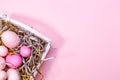 Eggs in a white tray. Creative Easter concept. Modern solid pink