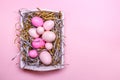 Eggs in a white tray. Creative Easter concept. Modern solid pink