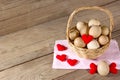 Eggs in a wicker basket with heart-shaped on wooden table Royalty Free Stock Photo