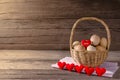 Eggs in a wicker basket with heart-shaped on wooden table Royalty Free Stock Photo