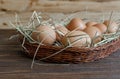 Eggs in wicker basket on table close-up Royalty Free Stock Photo