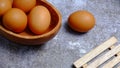 Eggs in a wooden bowl on a table that is neatly and simply arranged which gives an elegant and exclusive impression
