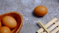 Eggs in a wooden bowl on a table that is neatly and simply arranged which gives an elegant and exclusive impression.