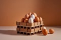 Eggs in a wooden box on a white table and orange background Royalty Free Stock Photo