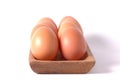 eggs in wooden square bowl isolated white background Royalty Free Stock Photo