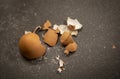 Eggshells from a brown hardboiled egg on a black countertop Royalty Free Stock Photo