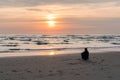 Egmond-aan-Zee, Netherlands, 09-24-2016: Girl at the seafront sunset Royalty Free Stock Photo