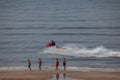 Egmond aan Zee, Netherlands - July 18, 2019: a member of the dutch coastguard on a jet ski in the north sea close to the beach Royalty Free Stock Photo