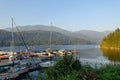 A marina full of boats surrounded by a beautiful calm ocean and forested shores, outside Egmont on the Sunshine Coast