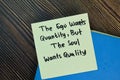 The ego wants quantity, but the soul wants quality write on sticky notes isolated on Wooden Table. Motivation concept Royalty Free Stock Photo