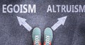 Egoism and altruism as different choices in life - pictured as words Egoism, altruism on a road to symbolize making decision and