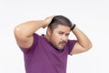 A egotistical man posing trying to look cool and sexy, but looking very awkward and cringe instead. Wearing a purple waffle shirt