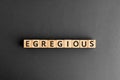 Egregious - word from wooden blocks with letters