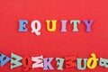 EGUITY word on red background composed from colorful abc alphabet block wooden letters, copy space for ad text. Learning english Royalty Free Stock Photo