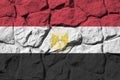 Egypt flag depicted in paint colors on old stone wall closeup. Textured banner on rock wall background Royalty Free Stock Photo