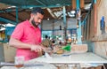 Egyptian market worker cleaning fresh fish