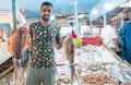 Egyptian seller showing big fresh fish