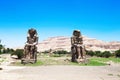 two massive stone statues of Pharaoh Amenhotep III