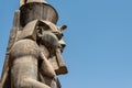 Egypt Luxor Temple. granite Statue of Ramesses II seated in front of columns