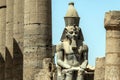 Egypt Luxor Temple. granite Statue of Ramesses II seated in front of columns