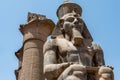 Egypt Luxor Temple. granite Statue of Ramesses II seated in front of columns