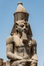 Egypt Luxor Temple. granite Statue of Ramesses II seated in front of columns