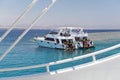 Egypt, Sharm el Sheikh - July 23, 2021. A white ship, people are snorkeling in the red sea. Tiran island