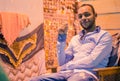 Portrait of arabian seller sitting in chair at night