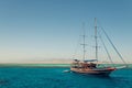 Sailing tour boat above clear sea