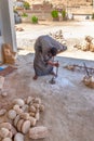 Egyptian artisan drilling a cylindrical hole into granite stone for making a vessel