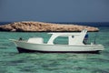 Egyptian beach with rock island and boat at Red sea Royalty Free Stock Photo