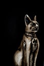 Egyptian black bastet cat figurine on black background Royalty Free Stock Photo