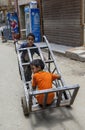 Egyptian boys play with a goods trolley in Cairo.