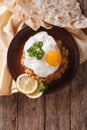 Egyptian breakfast: ful medames with a fried egg. vertical top v