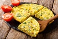 Egyptian breakfast: omelet Igga with greens, onions closeup. horizontal