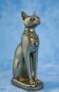 Egyptian cat Bast or Bastet, solar and war goddess, isolated on blue