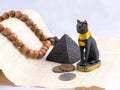 Egyptian cat, a pyramid and papyrus from travels. Royalty Free Stock Photo