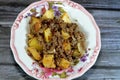 Egyptian cuisine of Fried potato cubes then cooked with minced beef meat with oil, garlic, onion, tomatoes and pepper served in Royalty Free Stock Photo