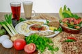 Egyptian Dynamite breakfast platter with flafel, marinated fried eggplant, boiled egg, hummus, potato, foul, beans, pita bread,