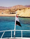 Egyptian flag on the background of the azure waters of the Red Sea